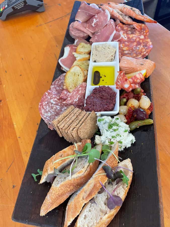 Waiheke: Scenic Taste and Graze Tour with Wine, Whisky, Beer - Mudbrick Restaurant and Vineyard: wine tasting with Hauraki Gulf views
